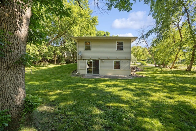 rear view of house with a yard