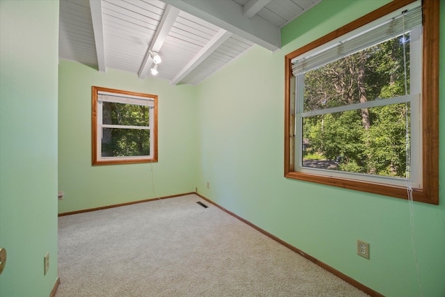 carpeted empty room featuring wooden ceiling and vaulted ceiling with beams