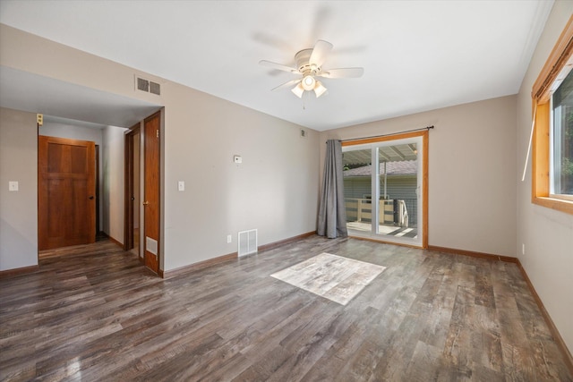 empty room featuring dark hardwood / wood-style floors and ceiling fan