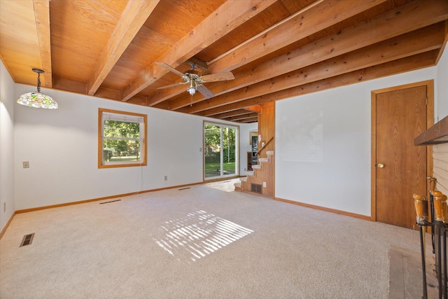 unfurnished room with beamed ceiling, light colored carpet, and ceiling fan