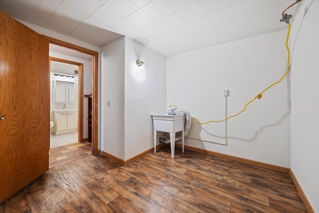 interior space with dark hardwood / wood-style flooring and sink