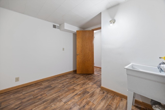 empty room featuring dark hardwood / wood-style floors and sink