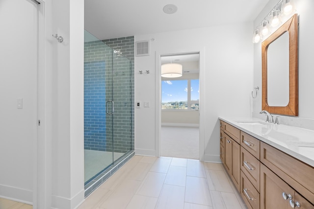 bathroom with tile patterned flooring, vanity, and a shower with door