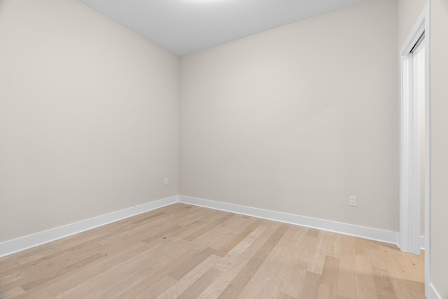 empty room with light hardwood / wood-style flooring