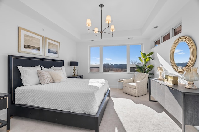 bedroom featuring a raised ceiling, light colored carpet, and a chandelier