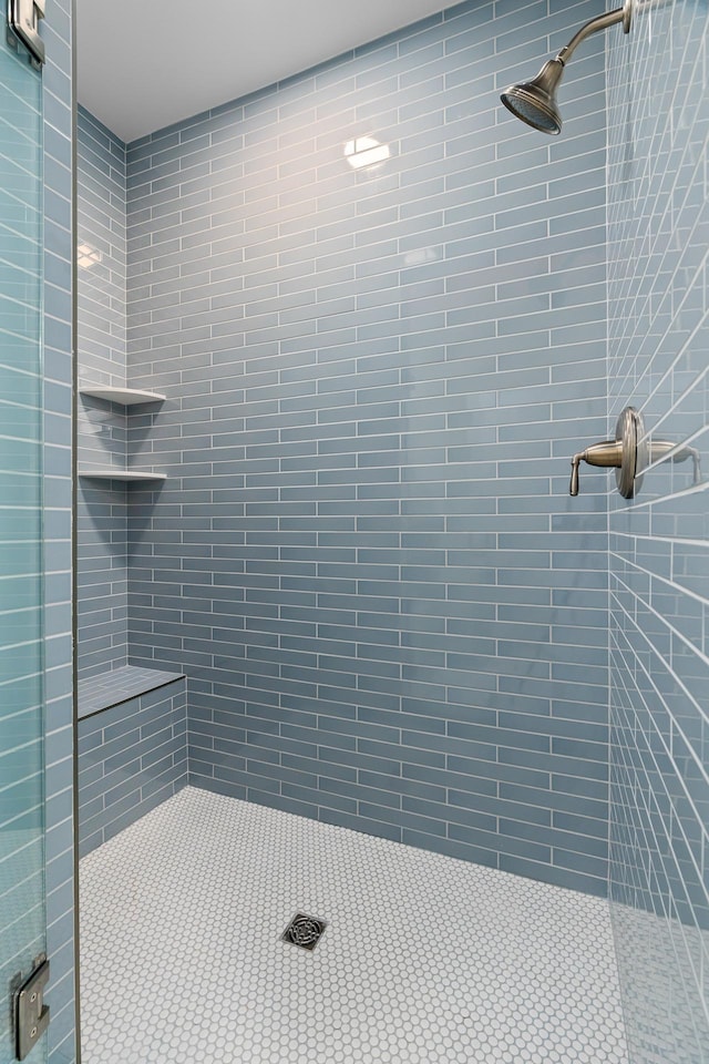 bathroom with tiled shower