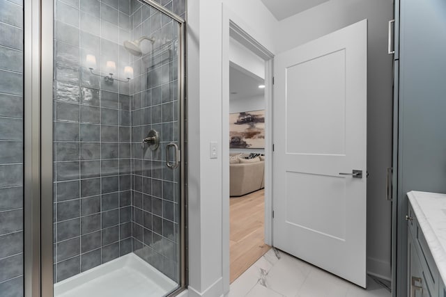 bathroom featuring tile flooring, an enclosed shower, and vanity