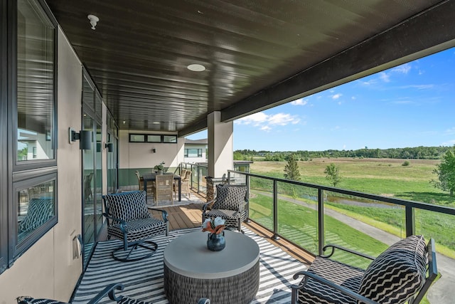 wooden deck with a rural view