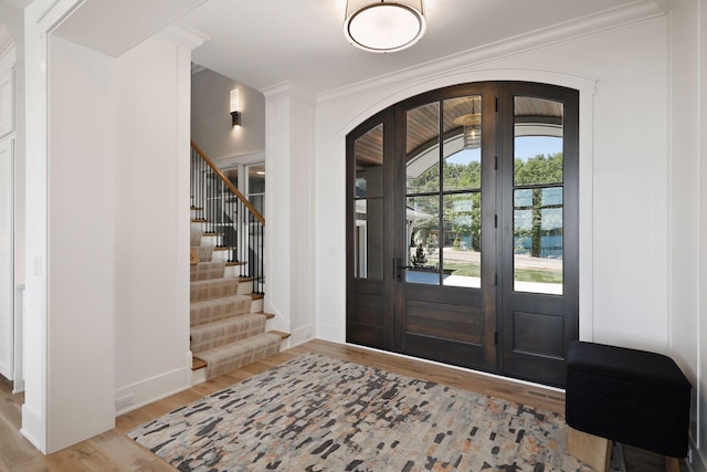 entrance foyer featuring light hardwood / wood-style flooring and ornamental molding