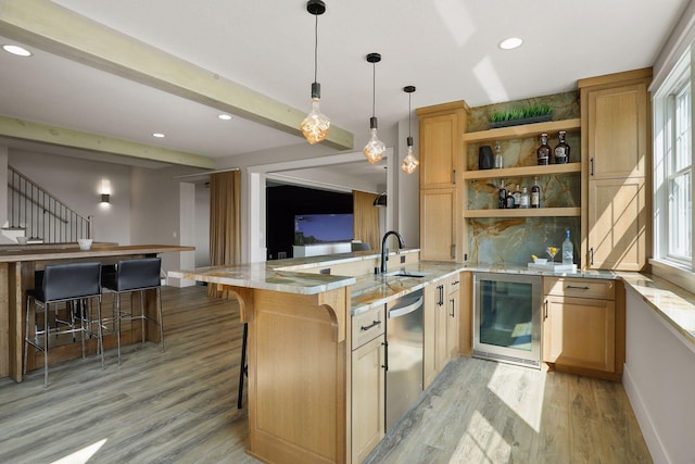 kitchen featuring light hardwood / wood-style floors, a breakfast bar, decorative light fixtures, wine cooler, and dishwasher