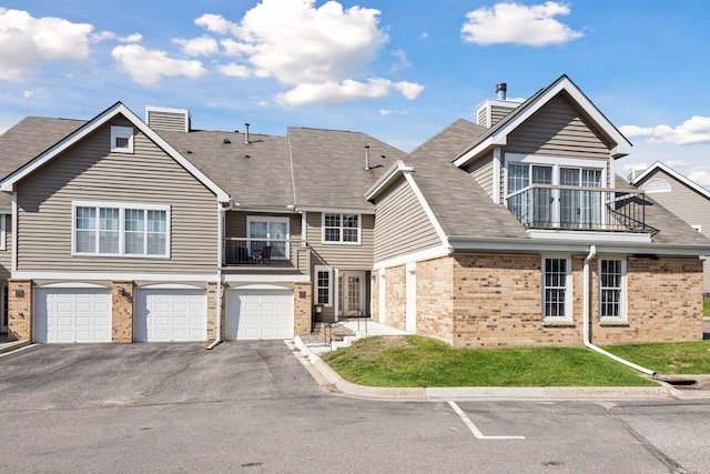 view of front of house featuring a balcony and a garage