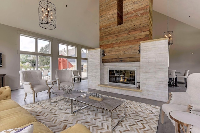 living room with a notable chandelier, light hardwood / wood-style floors, and high vaulted ceiling