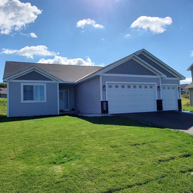 ranch-style home with a front lawn and a garage