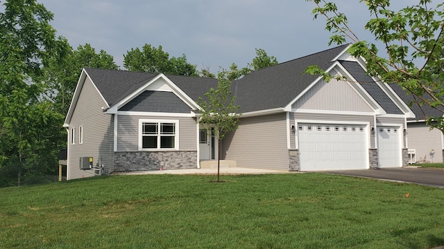 craftsman house featuring stone siding, aphalt driveway, an attached garage, and central air condition unit