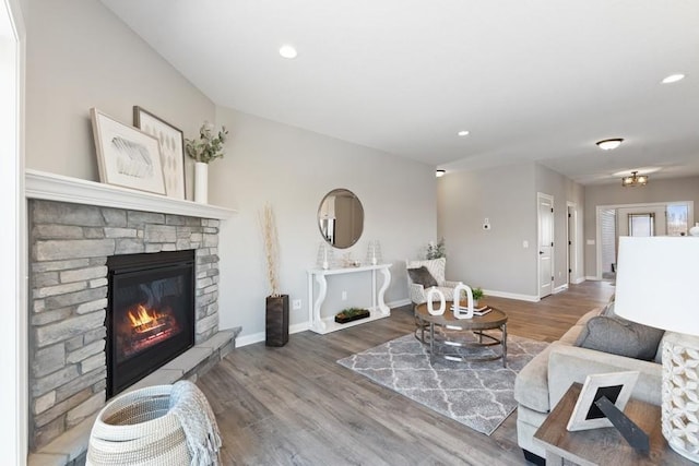 living area with a fireplace, baseboards, wood finished floors, and recessed lighting