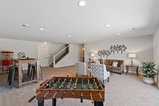 recreation room with recessed lighting, carpet flooring, and a textured ceiling