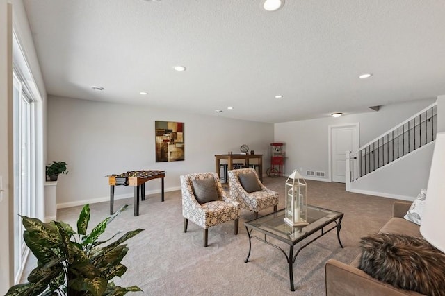 carpeted living room with baseboards, visible vents, stairway, and recessed lighting