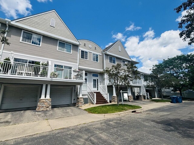 view of front of property featuring a garage and central AC unit