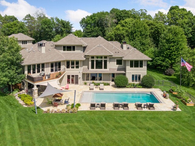 rear view of house featuring a yard and a patio