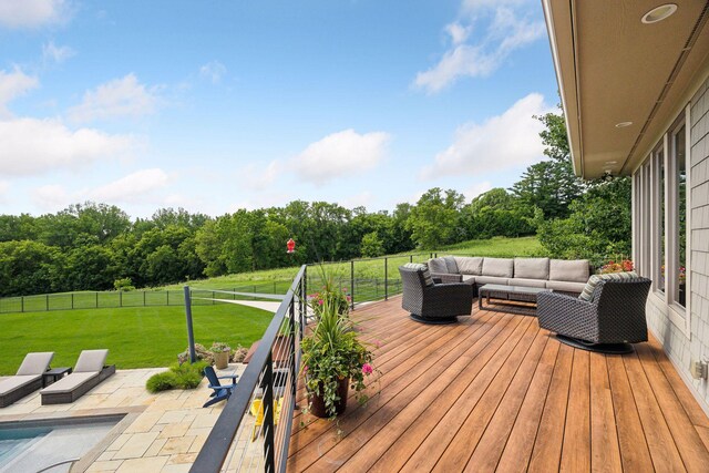 wooden terrace with an outdoor living space and a lawn