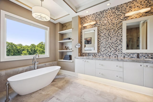 bathroom with vanity, plus walk in shower, backsplash, and tile patterned floors