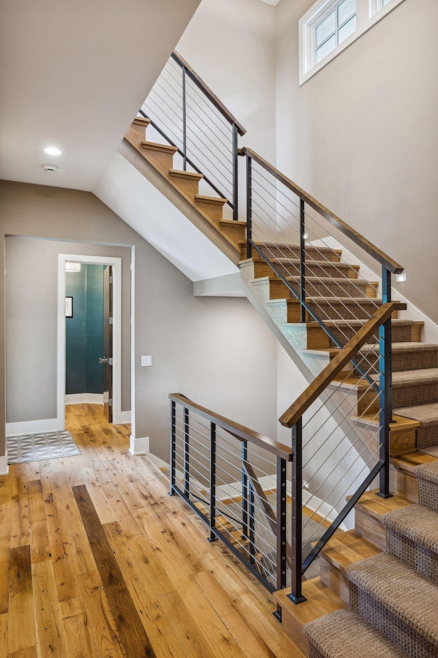 stairs with light hardwood / wood-style floors