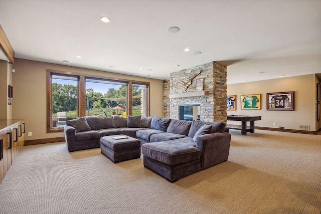 living room featuring a stone fireplace, light carpet, and pool table