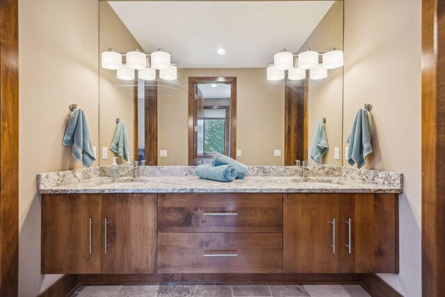 bathroom with lofted ceiling and dual bowl vanity