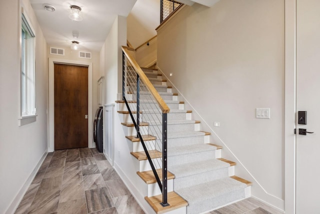 staircase featuring light tile patterned floors