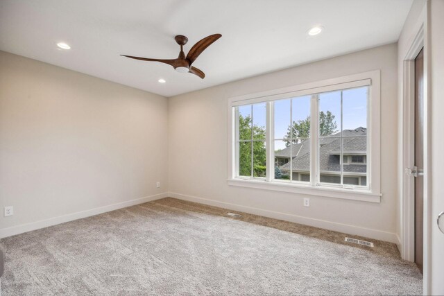 unfurnished room with ceiling fan and light colored carpet