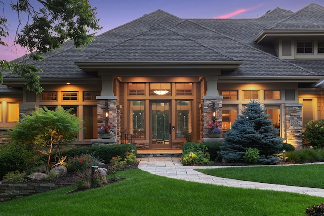 exterior space with french doors and a yard