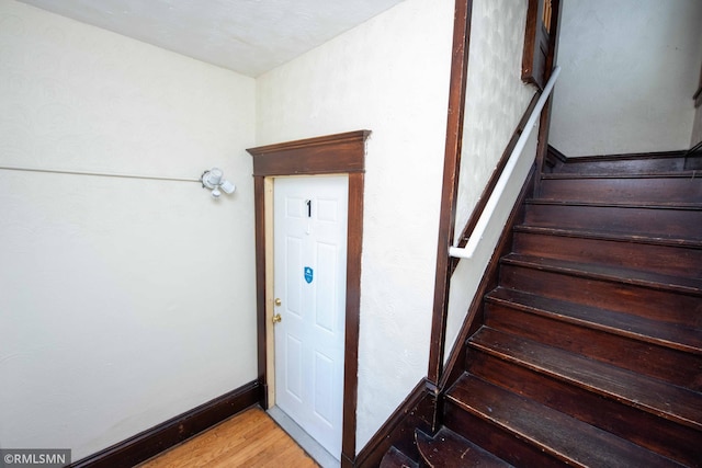 staircase featuring wood-type flooring