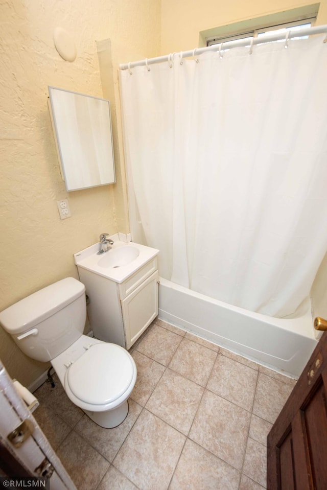 full bathroom featuring tile patterned flooring, vanity, toilet, and shower / bath combination with curtain