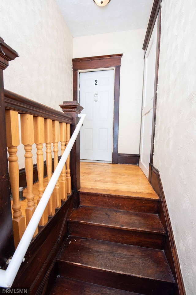 stairway featuring wood-type flooring