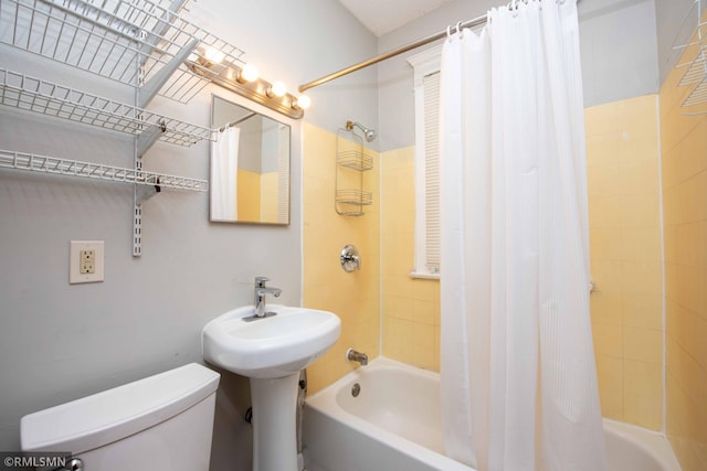 bathroom featuring toilet and shower / bathtub combination with curtain