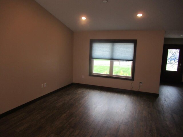 empty room with dark hardwood / wood-style floors