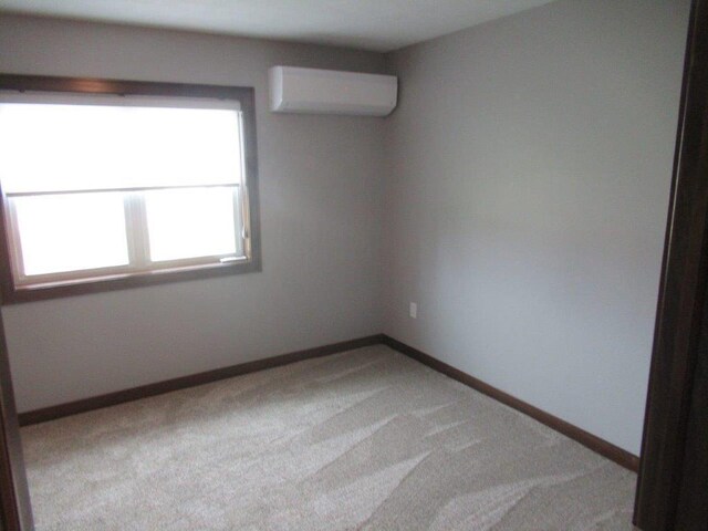 unfurnished room with carpet floors and a wall mounted air conditioner