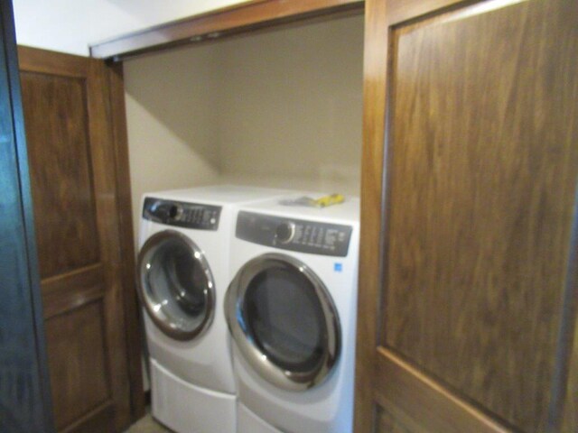 laundry area with washing machine and clothes dryer