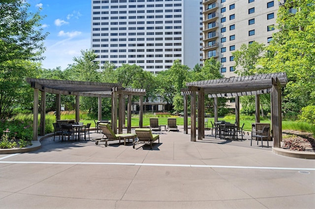 view of home's community with a patio area, a pergola, and outdoor dining space