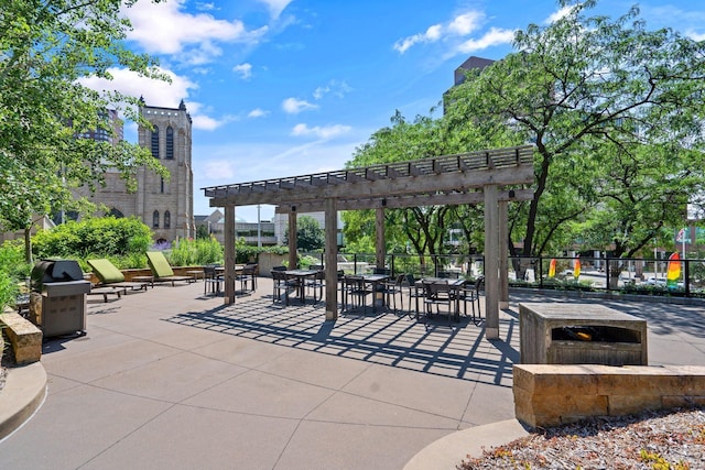 view of home's community featuring a pergola, a patio area, outdoor dining space, and fence