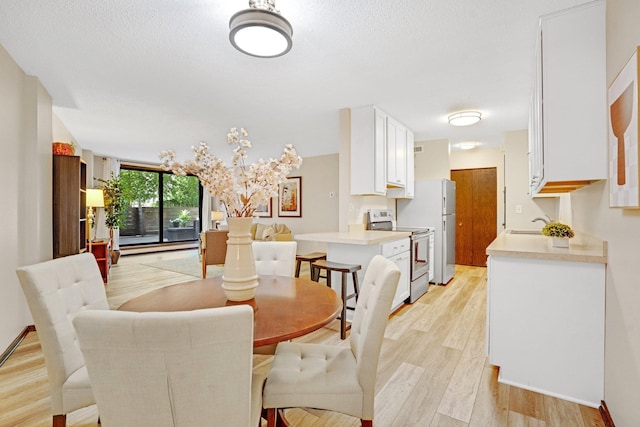 dining space with light wood-type flooring