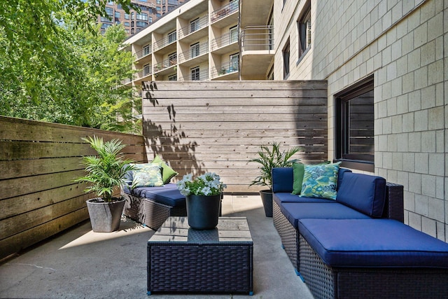 view of patio / terrace featuring an outdoor hangout area and fence