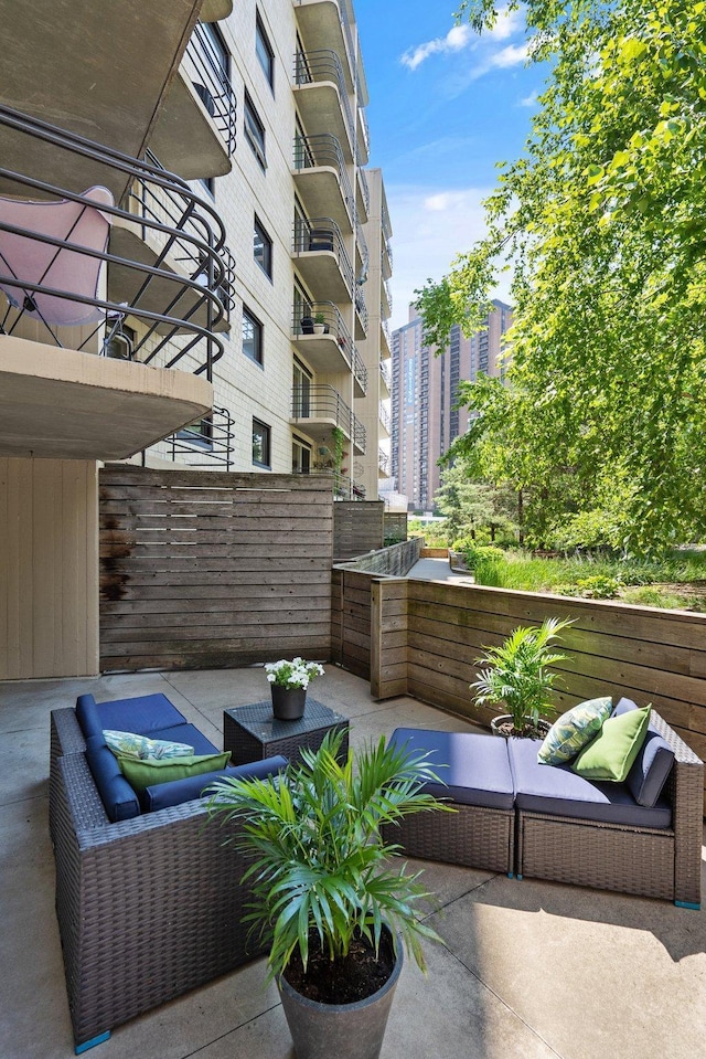 view of patio with an outdoor living space and a city view