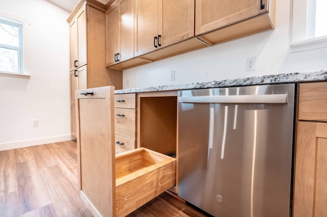 kitchen featuring light hardwood / wood-style flooring, light stone countertops, dishwasher, and light brown cabinets