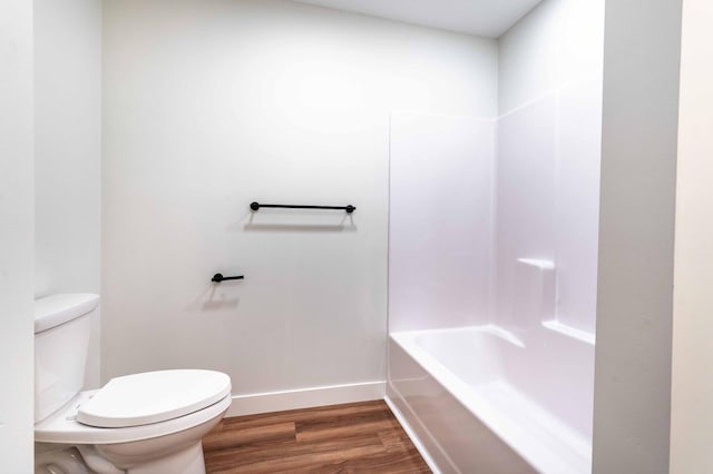 bathroom with toilet, hardwood / wood-style floors, and shower with separate bathtub