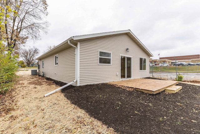 back of house featuring central air condition unit and a deck