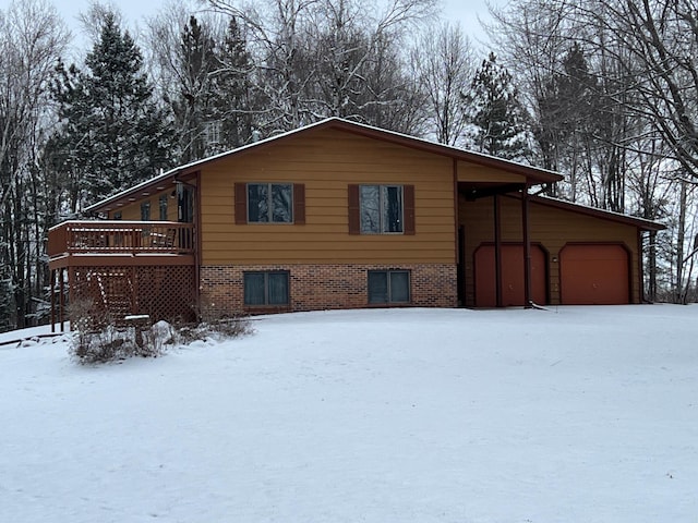 exterior space featuring a wooden deck and a garage