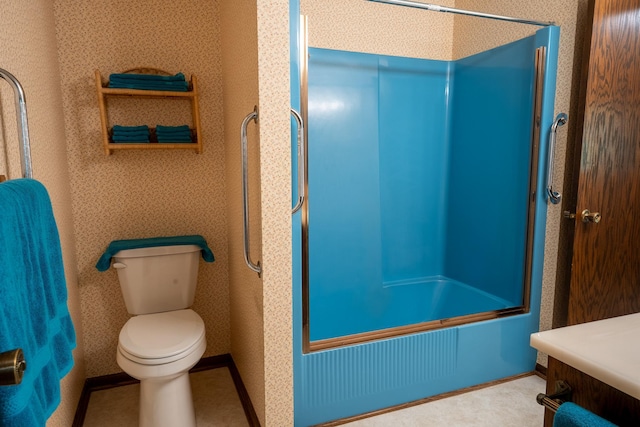 full bathroom featuring combined bath / shower with glass door, vanity, and toilet