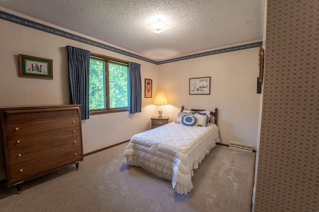 carpeted bedroom with crown molding and a textured ceiling