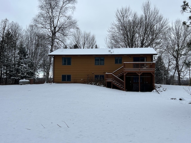 snow covered house with a deck